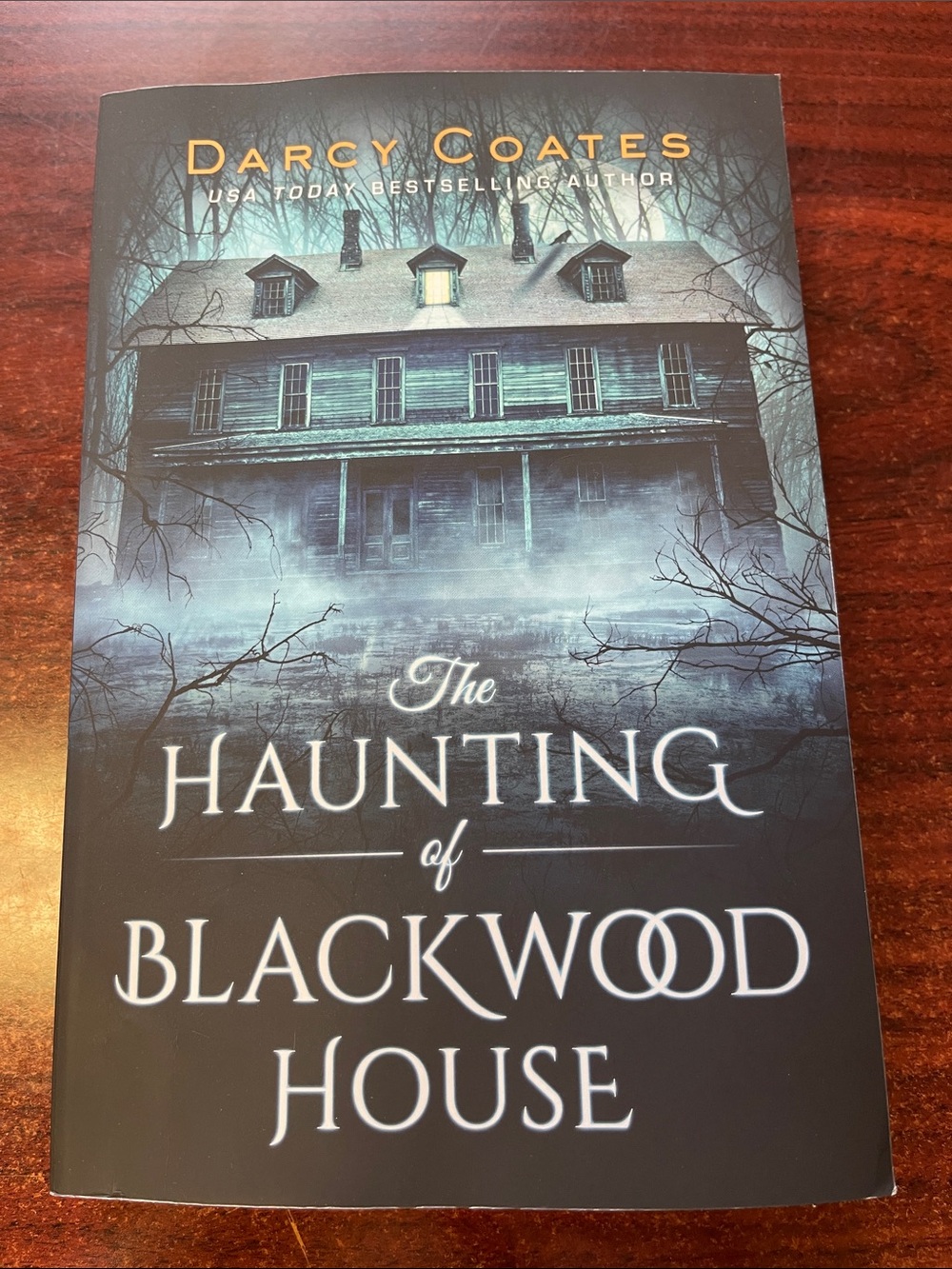 The Haunting of Blackwood House by Darcy Coates - Dark Teal & Black Paperback